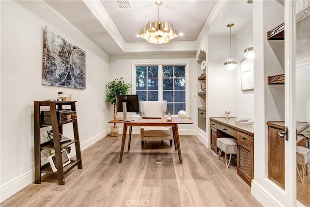 office space with a tray ceiling, light hardwood / wood-style flooring, crown molding, and a chandelier