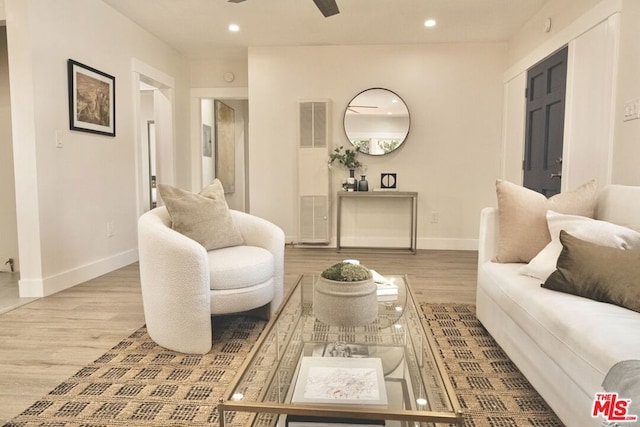 living room featuring ceiling fan and light hardwood / wood-style flooring