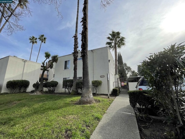 view of property exterior with a yard