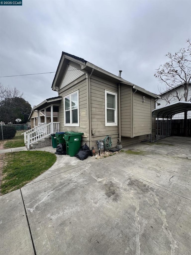 view of home's exterior with a carport