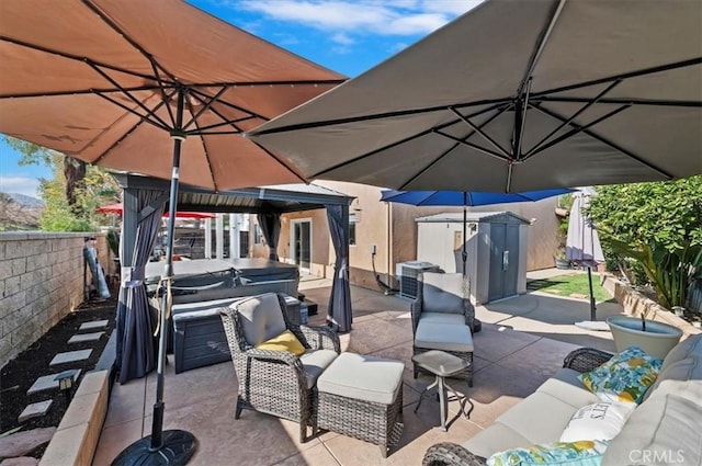 view of patio / terrace featuring an outdoor hangout area, central air condition unit, and a storage unit