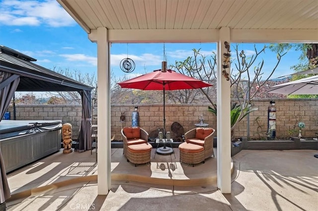 view of patio / terrace with a hot tub