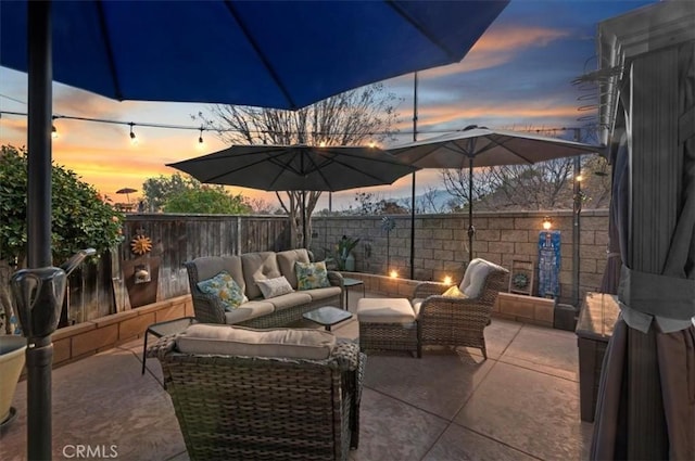 patio terrace at dusk with an outdoor living space