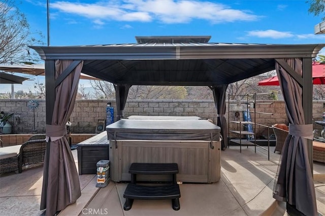 view of patio featuring a gazebo and a hot tub