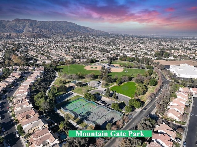 aerial view at dusk featuring a mountain view