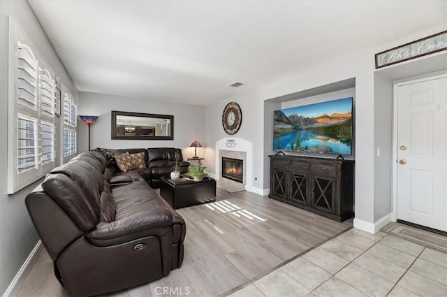 living room with a fireplace and light hardwood / wood-style floors