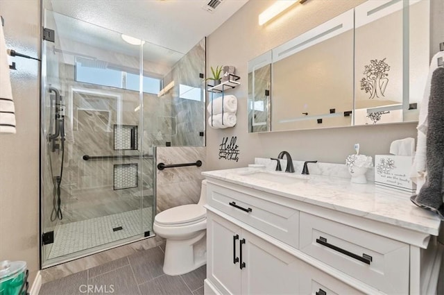 bathroom featuring vanity, toilet, and an enclosed shower