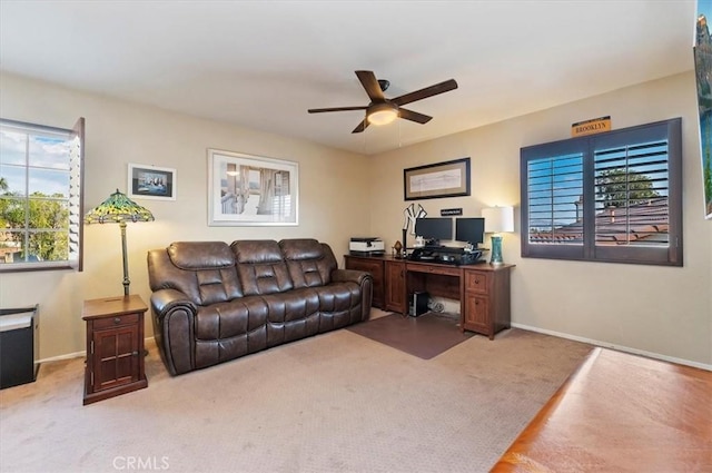 office space with ceiling fan and light colored carpet