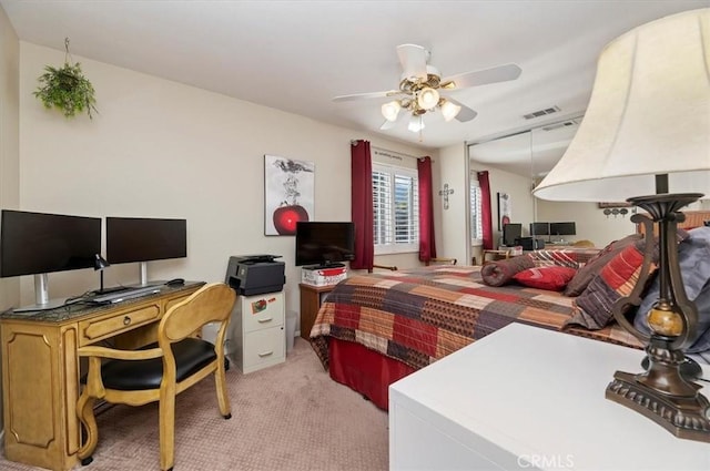 bedroom featuring light colored carpet and ceiling fan