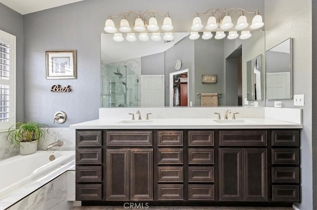 bathroom with vanity and shower with separate bathtub