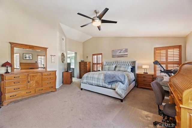 bedroom featuring vaulted ceiling, light colored carpet, and ceiling fan