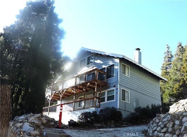 view of side of home with a balcony