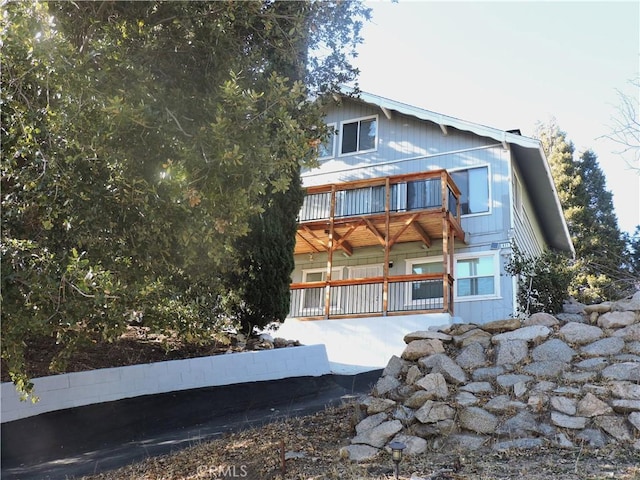 back of property featuring a balcony