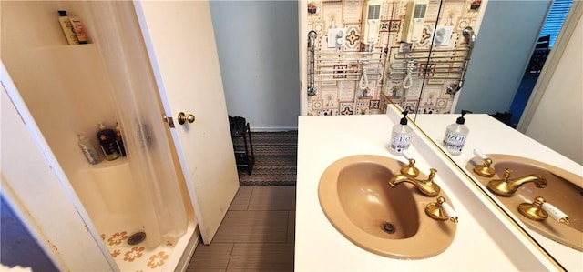 bathroom featuring walk in shower, vanity, and tile patterned floors