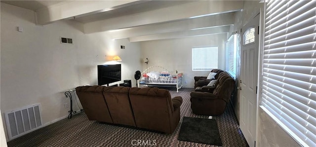 carpeted living room with beam ceiling