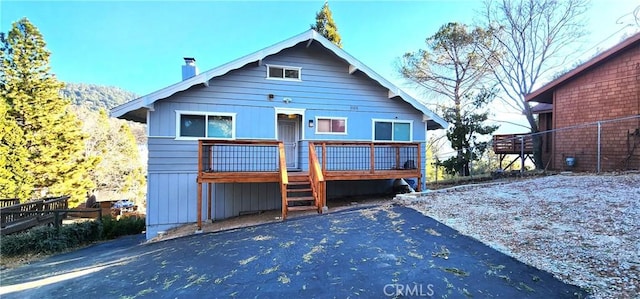 back of property featuring a wooden deck