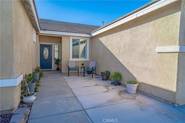 entrance to property with a patio area