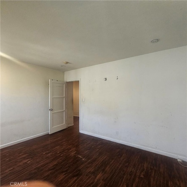 spare room with dark wood-type flooring