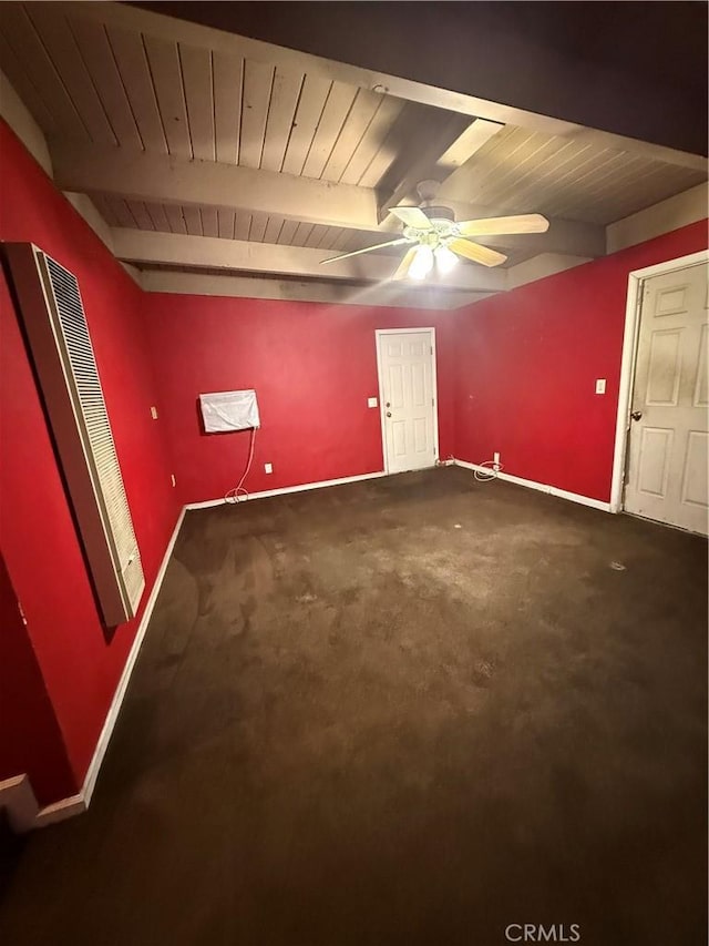 carpeted spare room featuring ceiling fan, wooden ceiling, and beamed ceiling