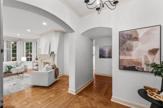 living room with crown molding, parquet floors, and an inviting chandelier