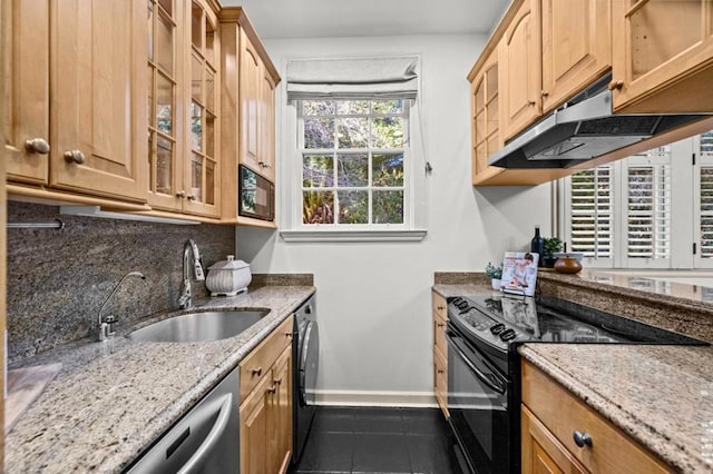 kitchen with sink, dark tile patterned floors, backsplash, black appliances, and light stone countertops