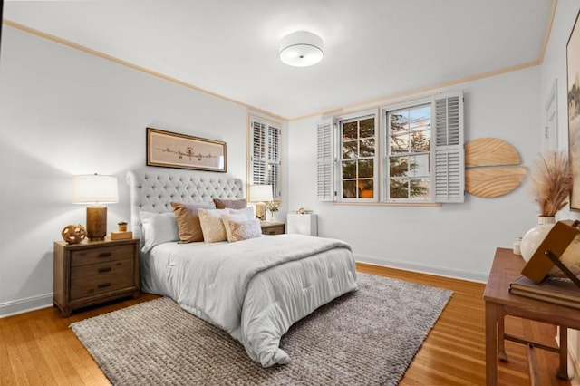 bedroom with hardwood / wood-style flooring and ornamental molding