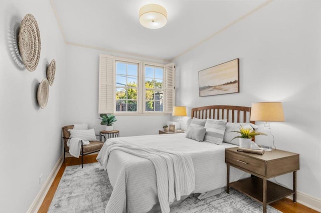 bedroom featuring hardwood / wood-style flooring and ornamental molding