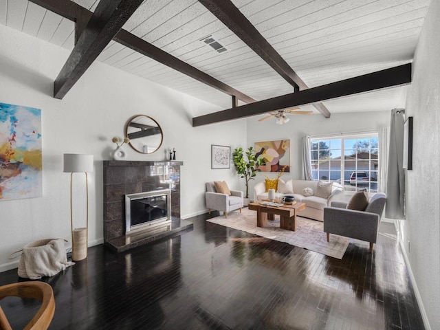 living room with wood-type flooring, ceiling fan, wood ceiling, a tile fireplace, and vaulted ceiling with beams