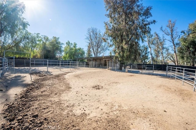 view of horse barn featuring a rural view