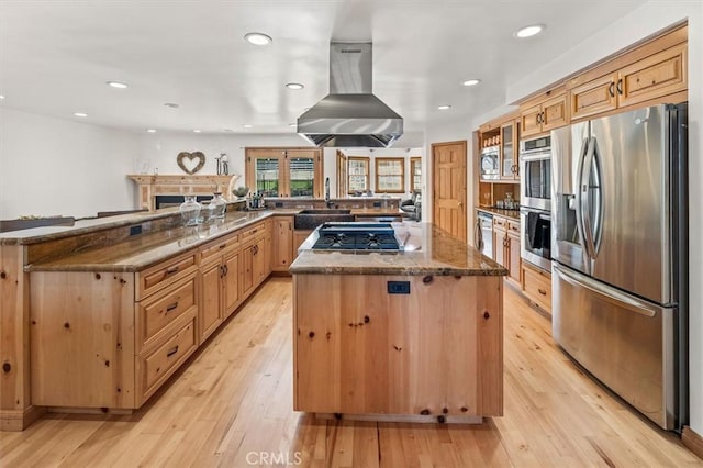 kitchen featuring a kitchen island, kitchen peninsula, island exhaust hood, light hardwood / wood-style flooring, and appliances with stainless steel finishes