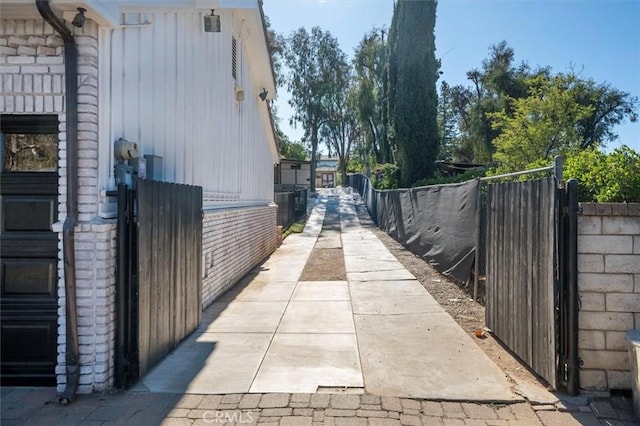 view of side of home with fence and central air condition unit