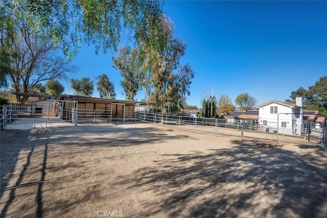 view of yard featuring a rural view and an outdoor structure