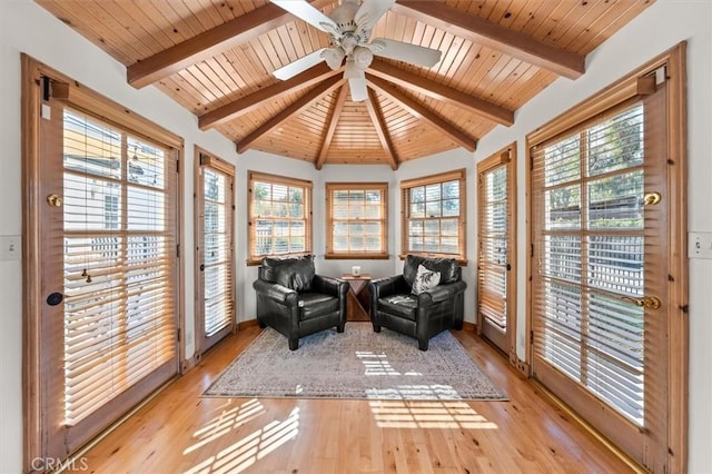 sunroom featuring wooden ceiling, vaulted ceiling with beams, and ceiling fan