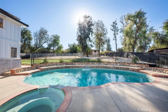 view of swimming pool with an in ground hot tub and a patio