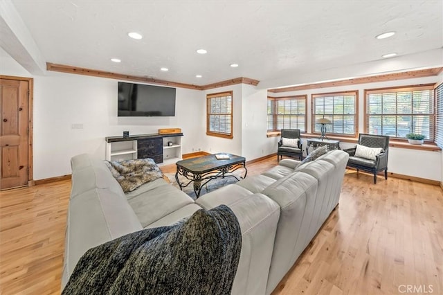 living room with baseboards, light wood-type flooring, and recessed lighting