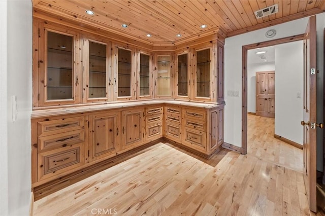 interior space featuring hardwood / wood-style floors, crown molding, and wood ceiling