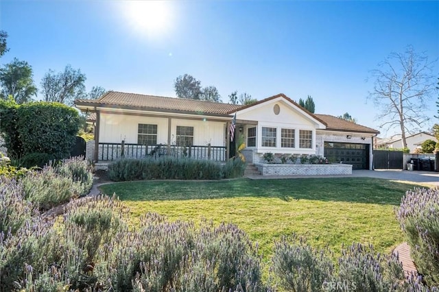 ranch-style house featuring a front lawn and a garage