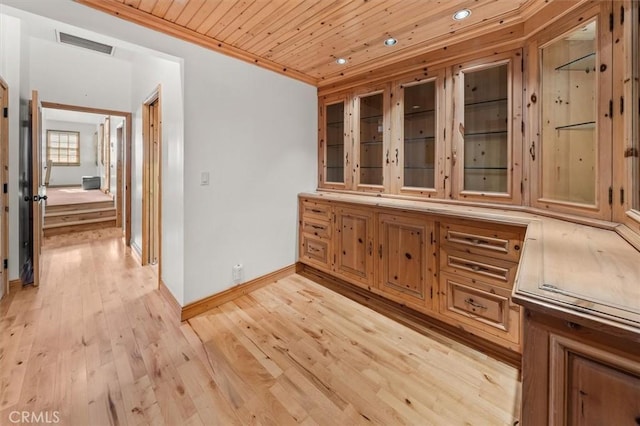 interior space with light wood-type flooring, wooden ceiling, and crown molding