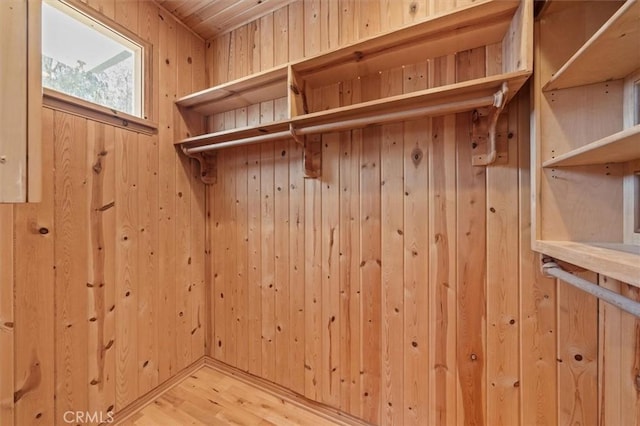 mudroom with wooden walls and light hardwood / wood-style floors