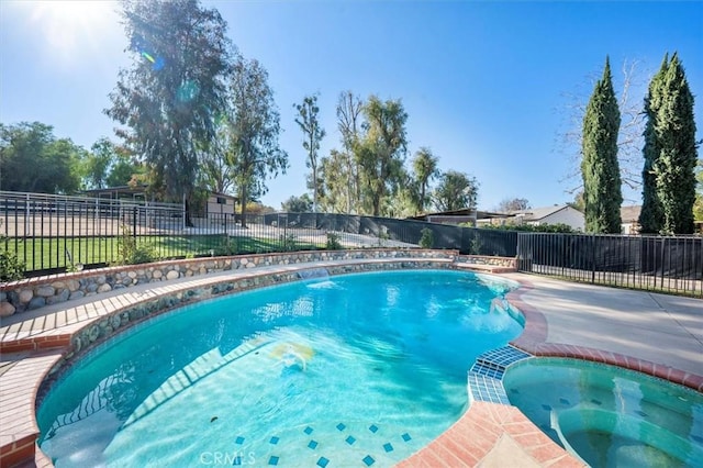 view of pool with an in ground hot tub