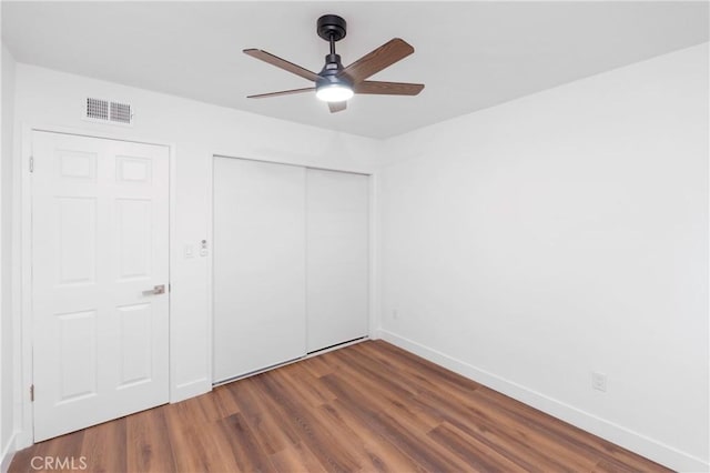 unfurnished bedroom with ceiling fan and hardwood / wood-style floors