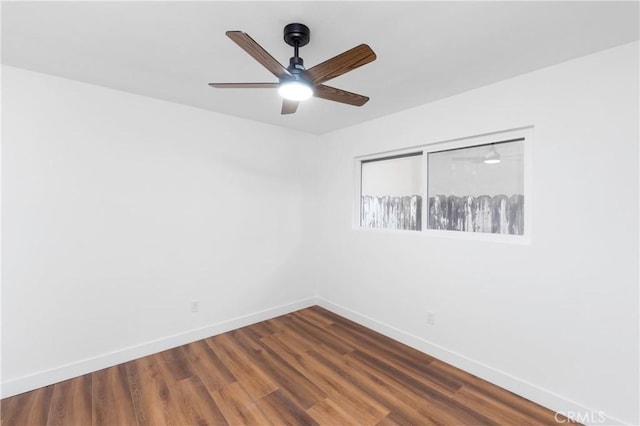 spare room featuring ceiling fan and dark hardwood / wood-style floors