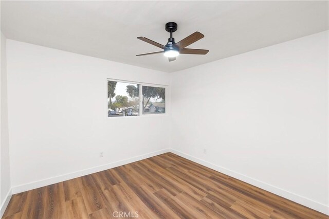 spare room with ceiling fan and hardwood / wood-style flooring