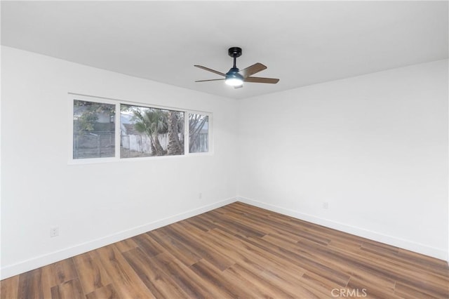 empty room with ceiling fan and hardwood / wood-style flooring