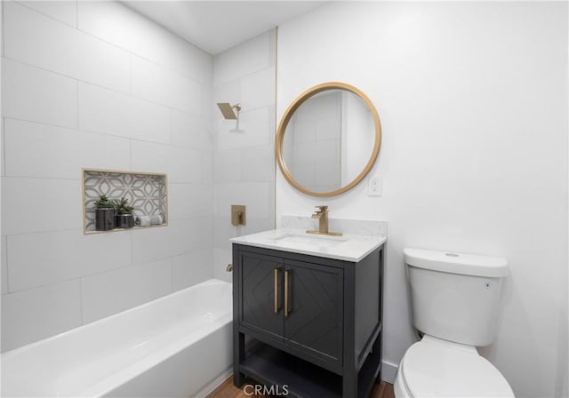 full bathroom with toilet, vanity, and tiled shower / bath combo