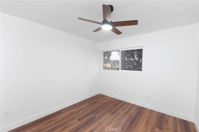 spare room featuring ceiling fan and dark hardwood / wood-style floors