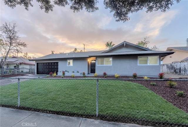 ranch-style house with a garage and a yard