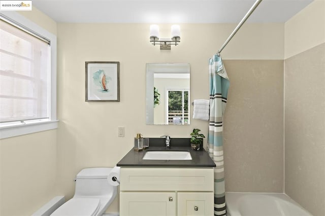 full bathroom featuring toilet, vanity, and shower / tub combo