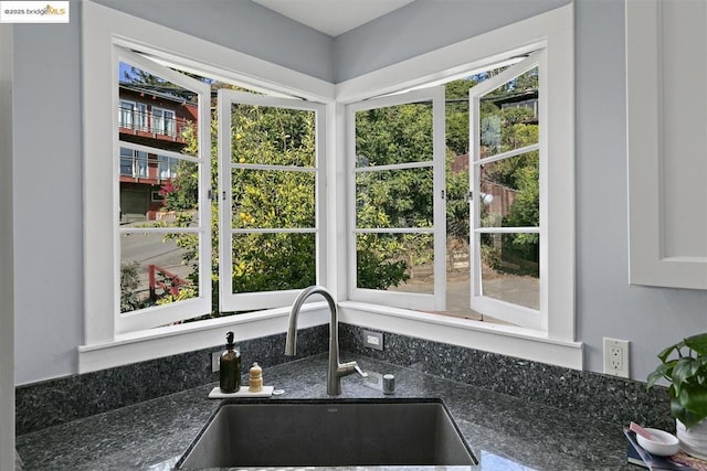 interior details with dark stone countertops and sink