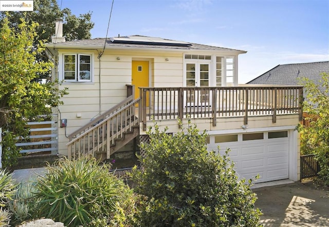 view of front of home featuring a garage and solar panels